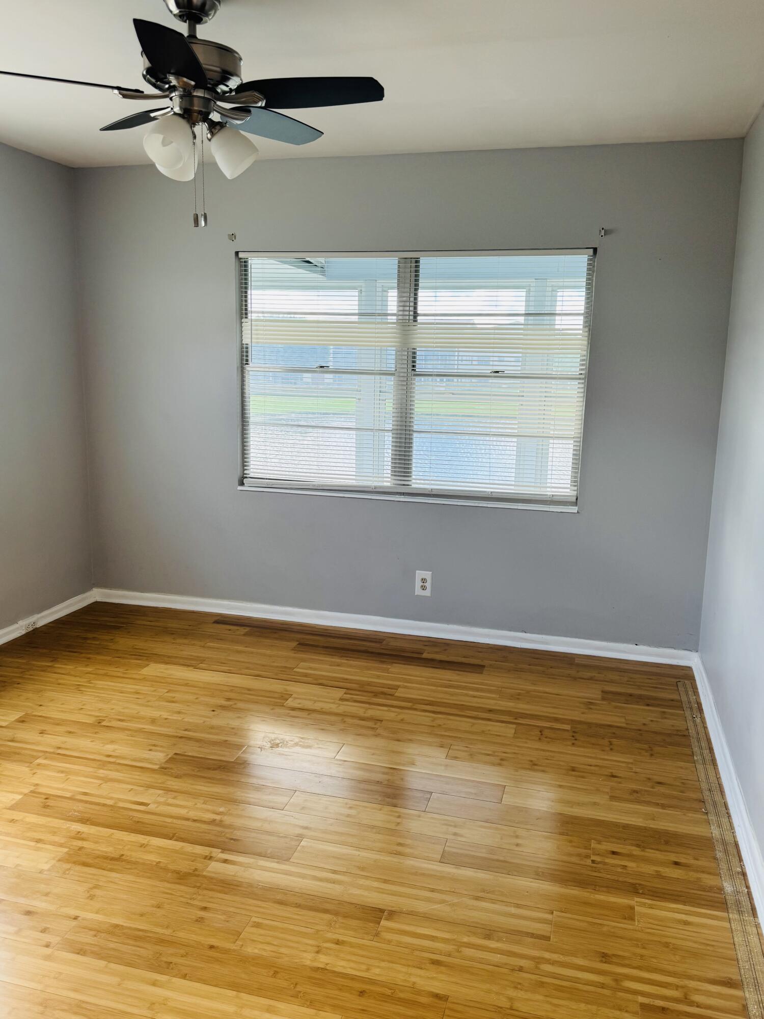 151 Brighton Drive, Unit D Boca Raton, FL 33434 - Photo 13 of 29 a view of a room with wooden floor and a window