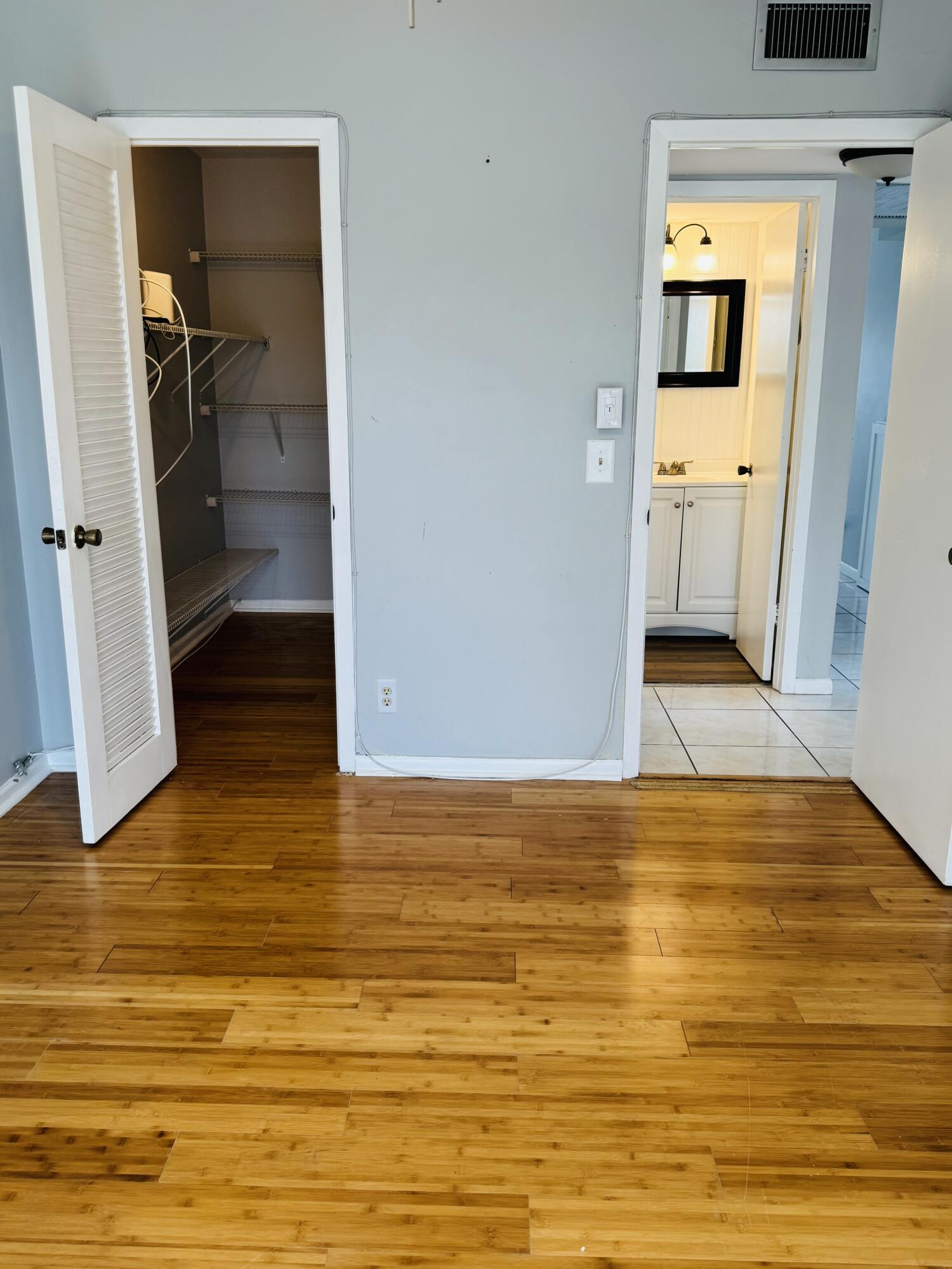 151 Brighton Drive, Unit D Boca Raton, FL 33434 - Photo 21 of 29 a view of empty room and wooden floor