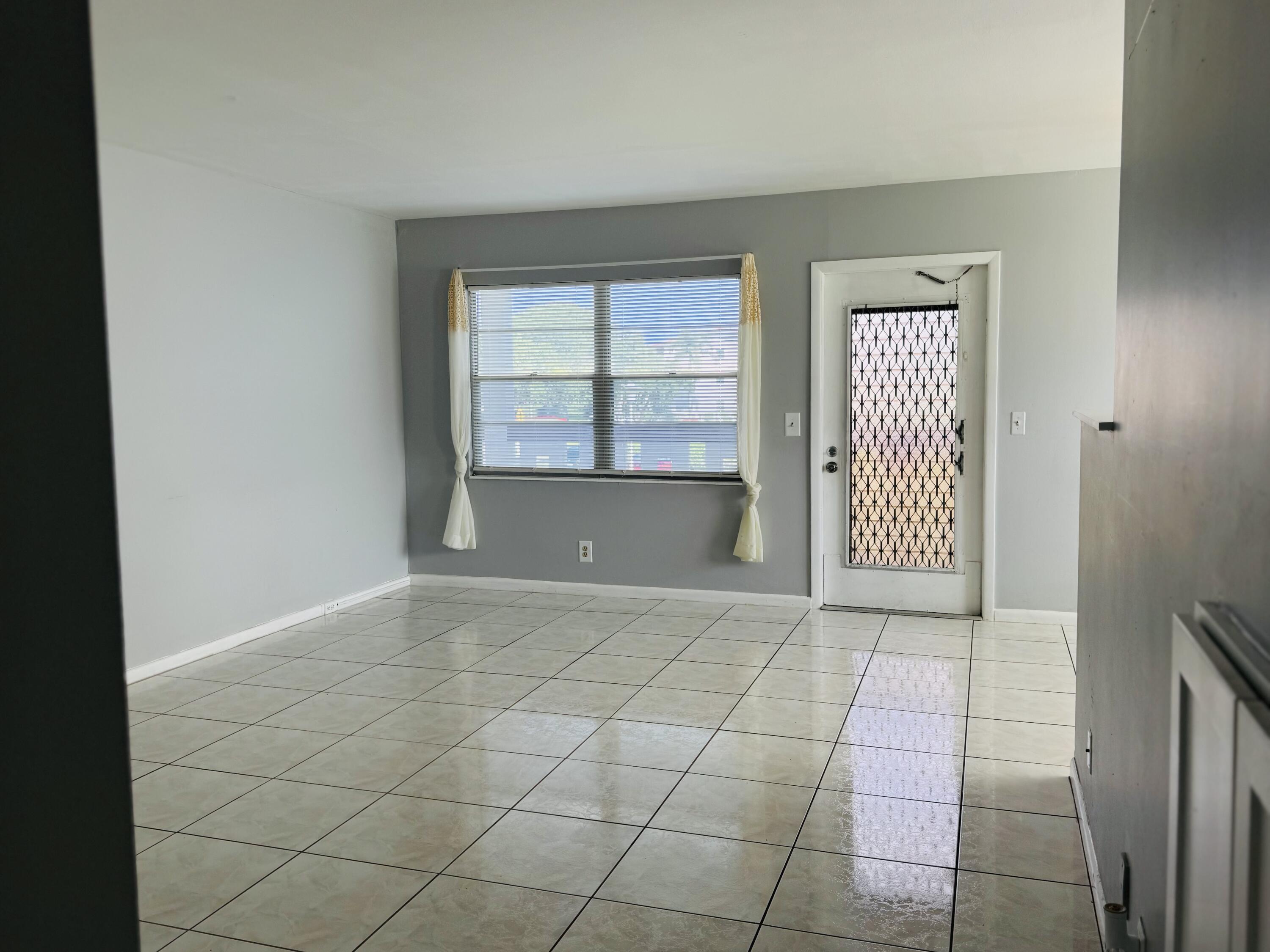 151 Brighton Drive, Unit D Boca Raton, FL 33434 - Photo 24 of 29 an empty room with windows