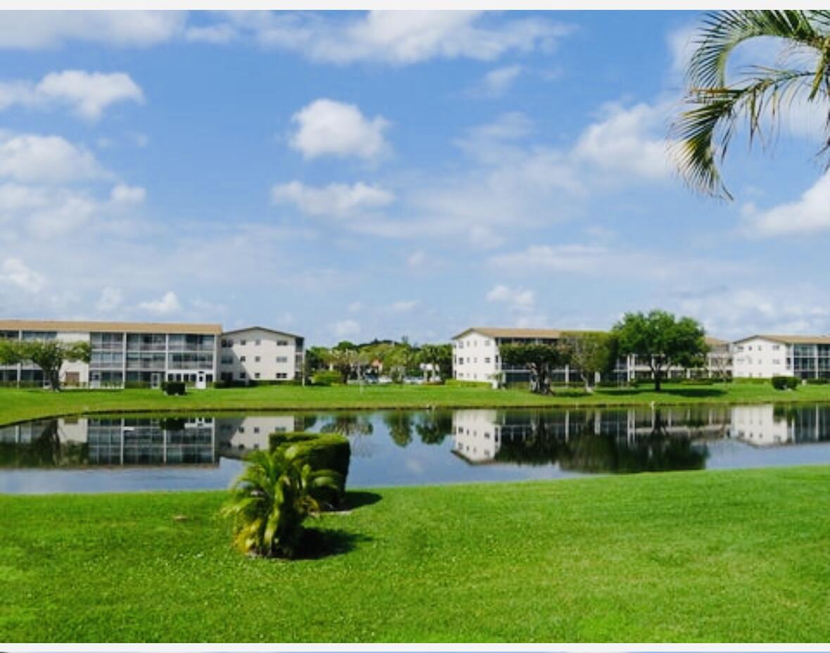 151 Brighton Drive, Unit D Boca Raton, FL 33434 - Photo 27 of 29 a swimming pool with outdoor seating and yard