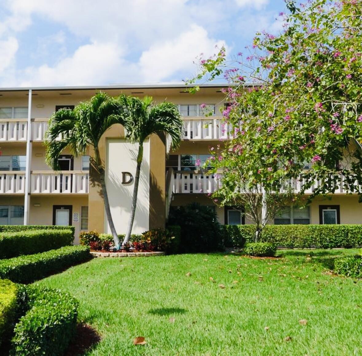 151 Brighton Drive, Unit D Boca Raton, FL 33434 - Photo 29 of 29 a front view of a building with garden