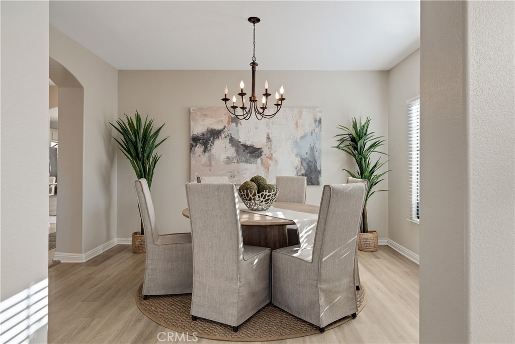 750 14th Street Manhattan Beach, CA 90266 - Photo 16 of 60 a dining room with furniture potted plants and wooden floor