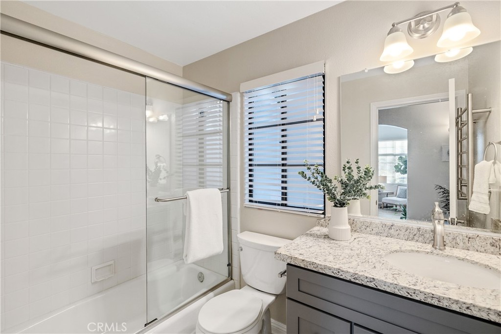 750 14th Street Manhattan Beach, CA 90266 - Photo 19 of 60 a bathroom with a granite countertop sink a toilet and shower