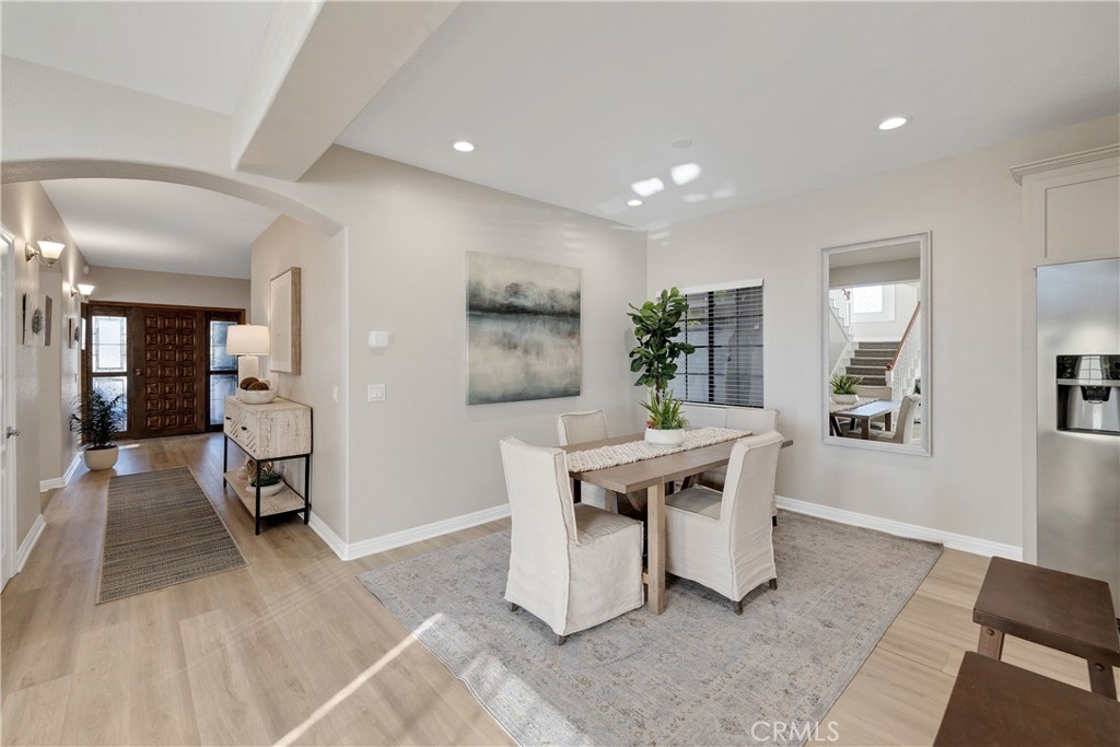 750 14th Street Manhattan Beach, CA 90266 - Photo 21 of 60 a dining hall with stainless steel appliances granite countertop a stove a sink a dining table and chairs with wooden floor