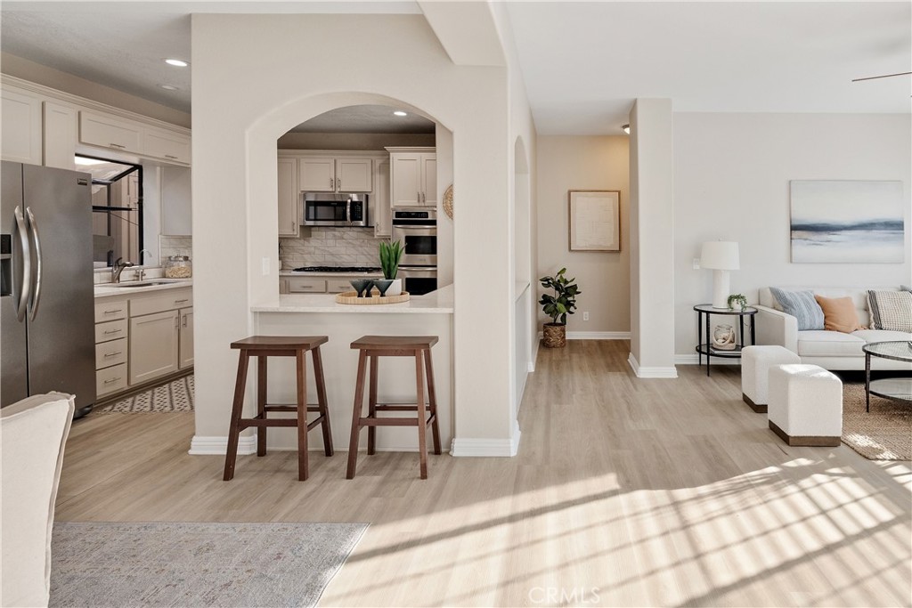 750 14th Street Manhattan Beach, CA 90266 - Photo 24 of 60 a living room with furniture and a wooden floor