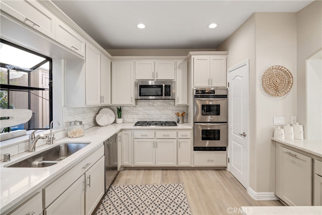 750 14th Street Manhattan Beach, CA 90266 - Photo 29 of 60 a kitchen with granite countertop a sink stove and refrigerator