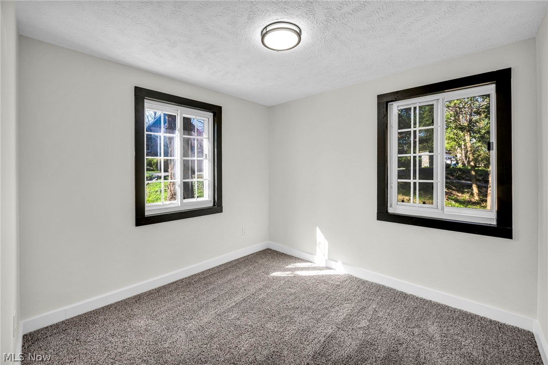 7339 River Road Olmsted Falls, OH 44138 - Photo 28 of 45 White interior walls featuring two windows with dark trim and white grilles