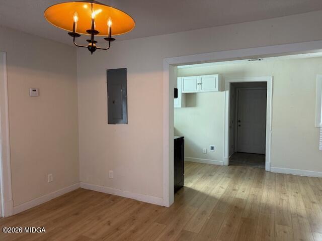 962 Troupe Street Macon, GA 31206 - Photo 3 of 11 an empty room with wooden floor and chandelier
