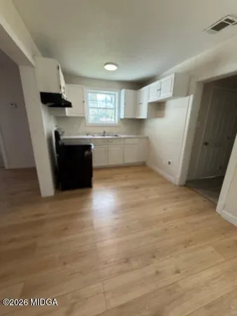 a kitchen with granite countertop a refrigerator and a stove