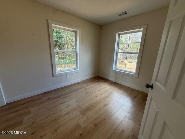 962 Troupe Street Macon, GA 31206 - Photo 7 of 11 a view of an empty room with wooden floor and a window