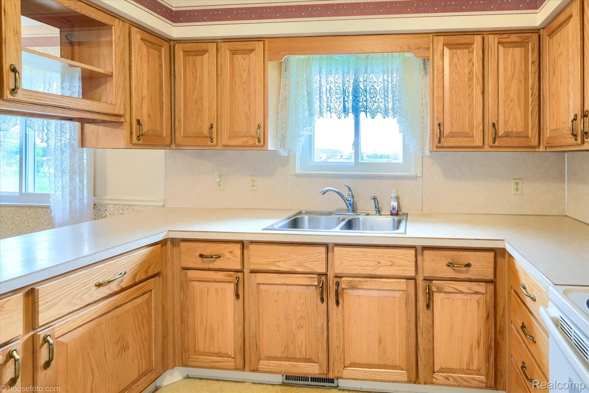 6080 Shattuck Road Saginaw, MI 48603 - Photo 20 of 35 Kitchen with light countertops, wood finish cabinetry, and white electric stove