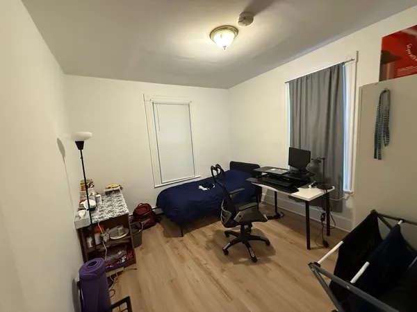 a view of a workspace with furniture and a window