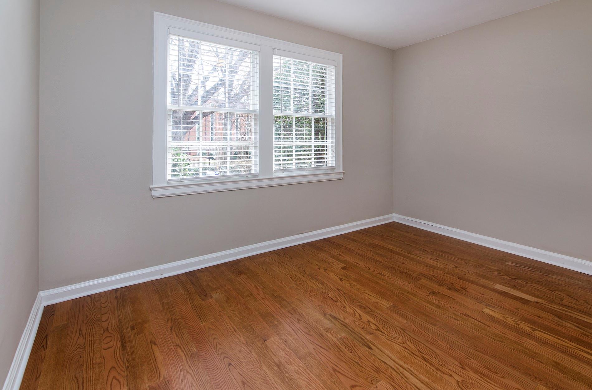 104 Colville Road, Unit 41A Charlotte, NC 28207 - Photo 14 of 21 a view of an empty room with wooden floor and a window