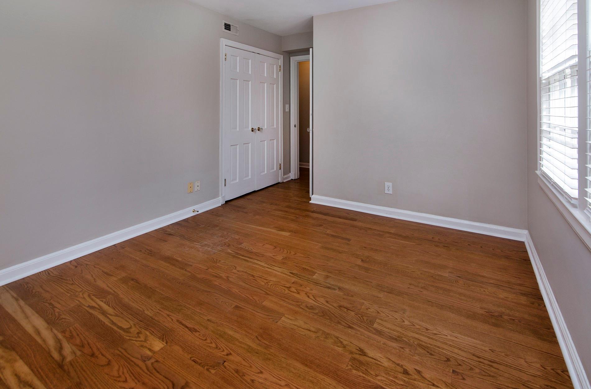 104 Colville Road, Unit 41A Charlotte, NC 28207 - Photo 16 of 21 a view of an empty room with wooden floor and a window
