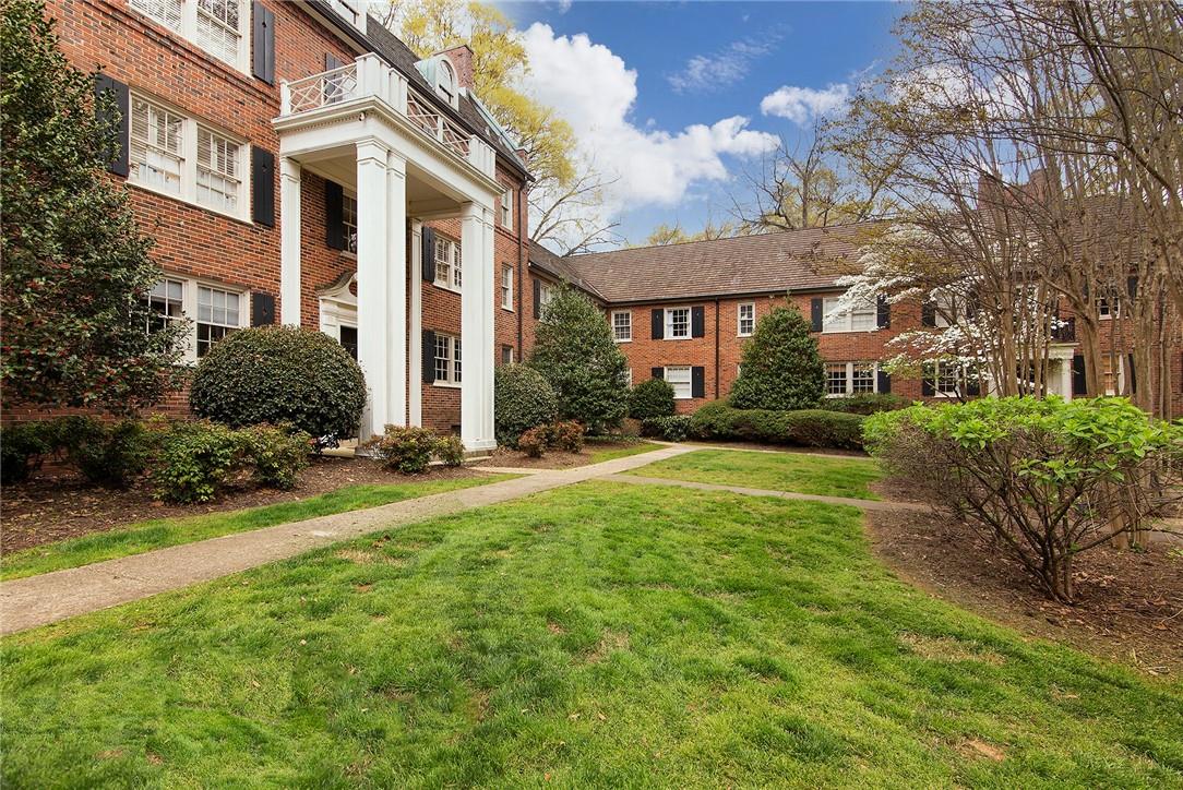 104 Colville Road, Unit 41A Charlotte, NC 28207 - Photo 17 of 21 a view of a white house next to a yard with plants and trees