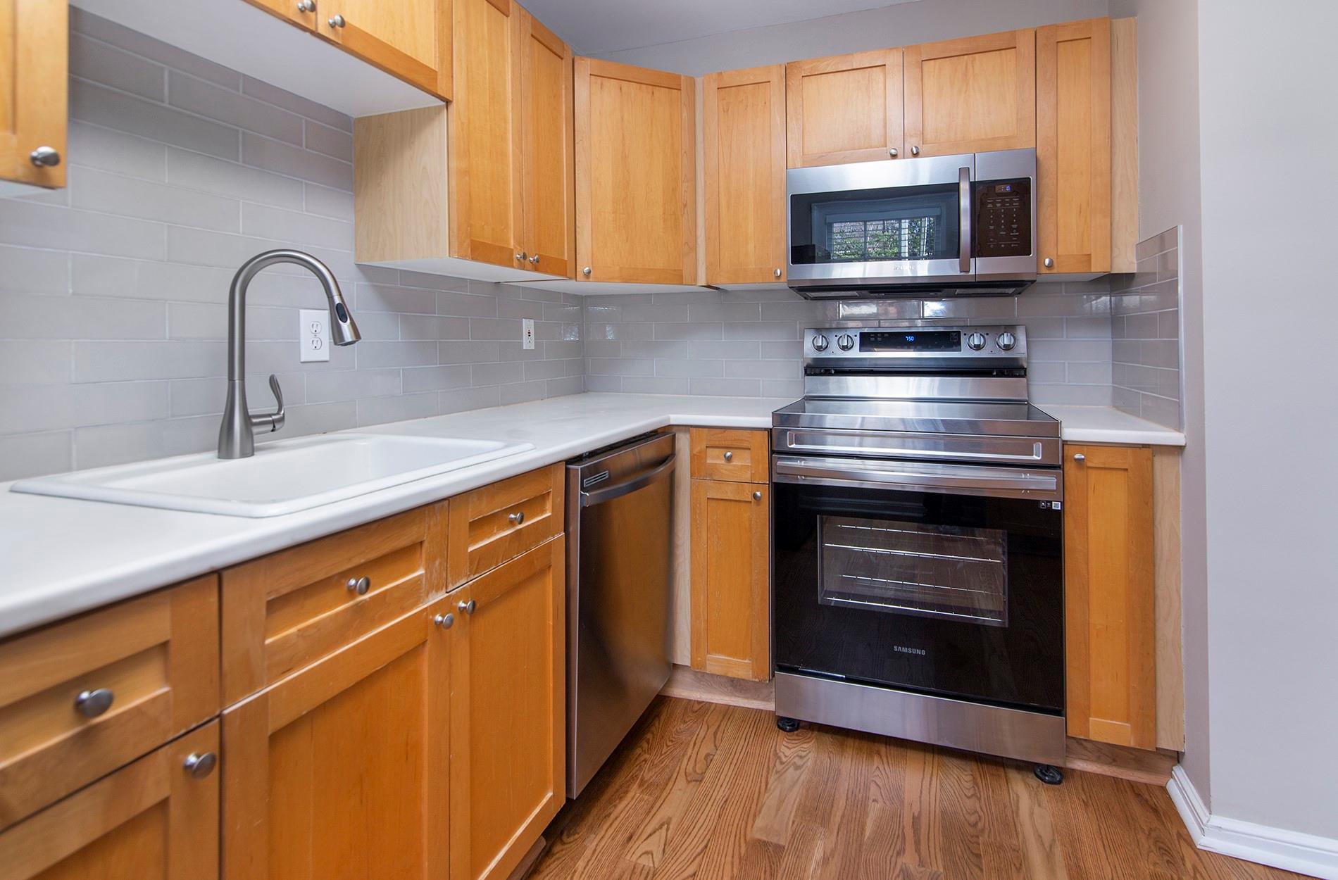 104 Colville Road, Unit 41A Charlotte, NC 28207 - Photo 5 of 21 a kitchen with a stove microwave and sink