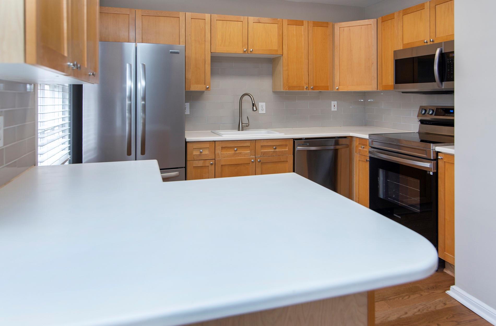 104 Colville Road, Unit 41A Charlotte, NC 28207 - Photo 7 of 21 a kitchen with stainless steel appliances a refrigerator sink and microwave