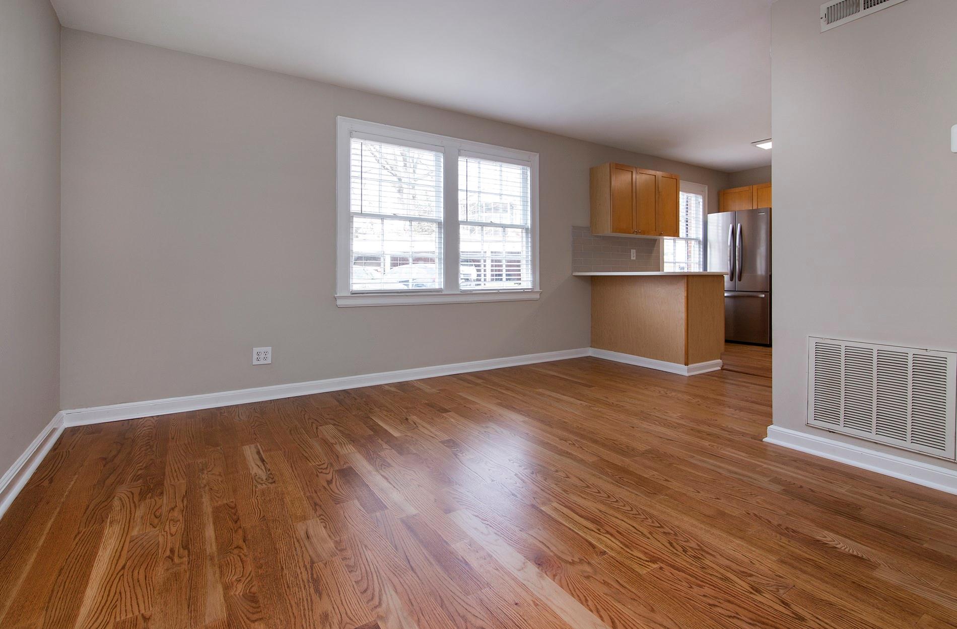 104 Colville Road, Unit 41A Charlotte, NC 28207 - Photo 9 of 21 an empty room with wooden floor and windows