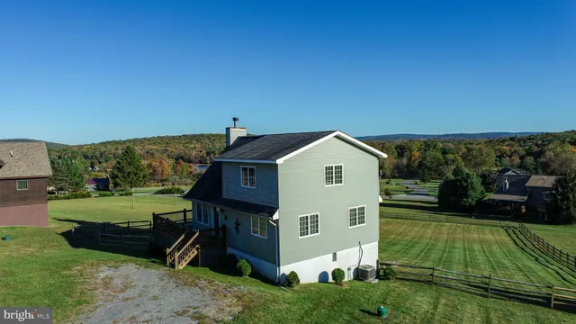 a living room with furniture a flat screen tv and a table