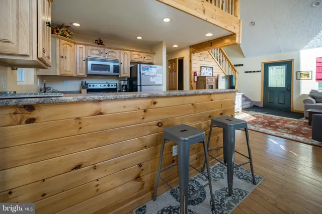 a kitchen with stainless steel appliances granite countertop a sink stove and cabinets
