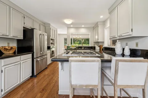 a kitchen with appliances a sink and cabinets