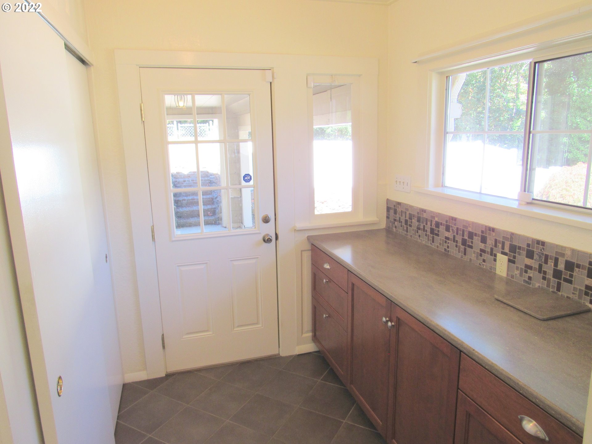 69 Pacific Place Longview, WA 98632 - Photo 12 of 32 a view of a kitchen with wooden floor and windows