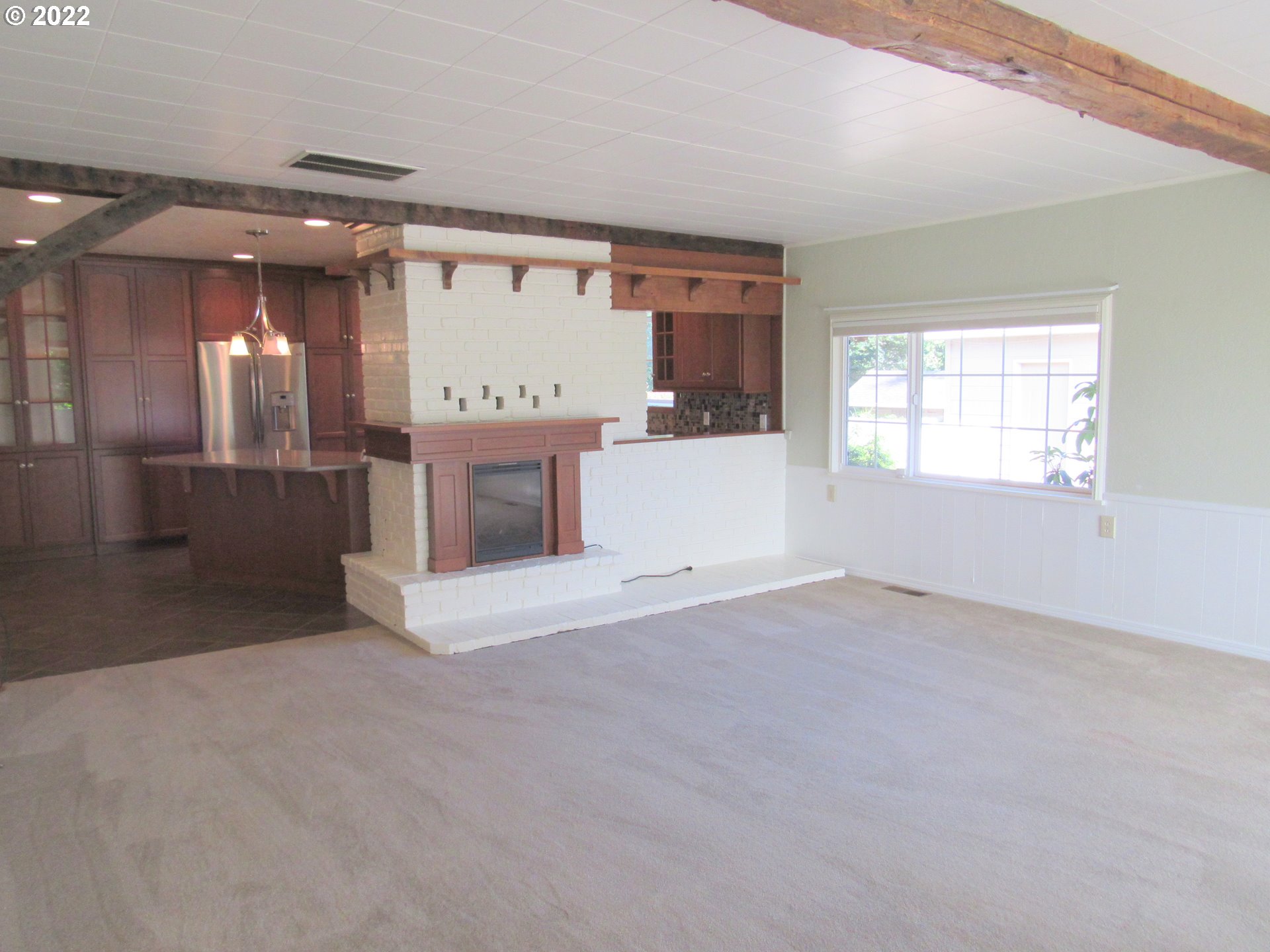 69 Pacific Place Longview, WA 98632 - Photo 5 of 32 a view of an empty room with a fireplace and a window