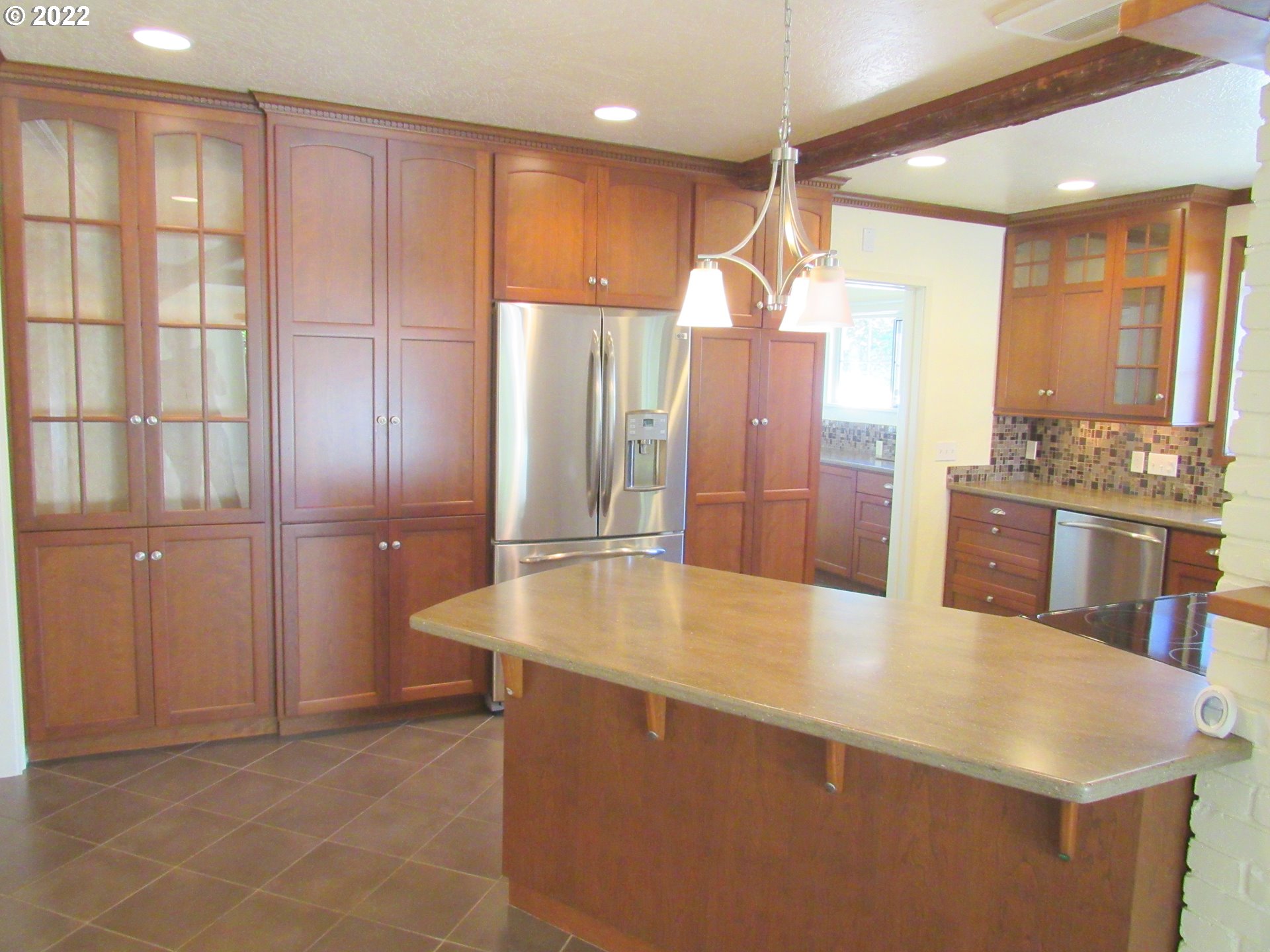 69 Pacific Place Longview, WA 98632 - Photo 8 of 32 a large kitchen with kitchen island a large counter top space appliances and a ceiling fan