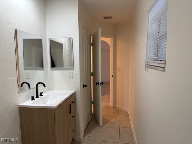 3906 13th Street West Lehigh Acres, FL 33971 - Photo 19 of 26 a bathroom with a sink and a mirror