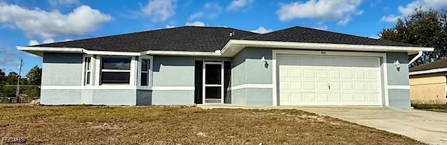 3906 13th Street West Lehigh Acres, FL 33971 - Photo 2 of 26 a front view of a house with a yard