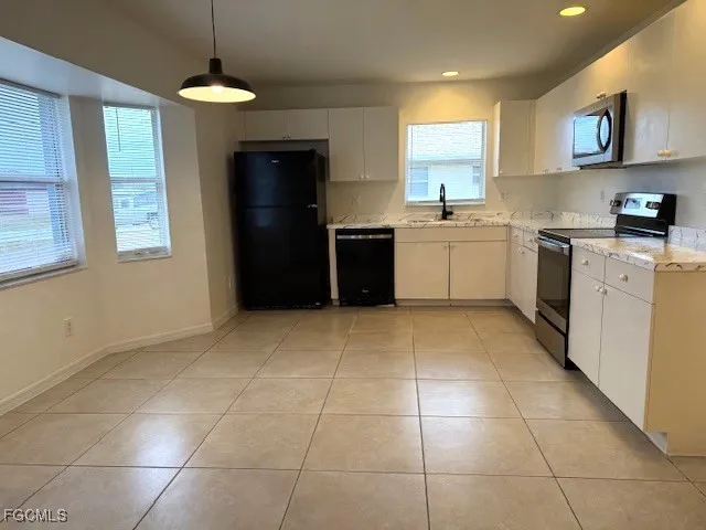 a kitchen with a stove a sink and a refrigerator