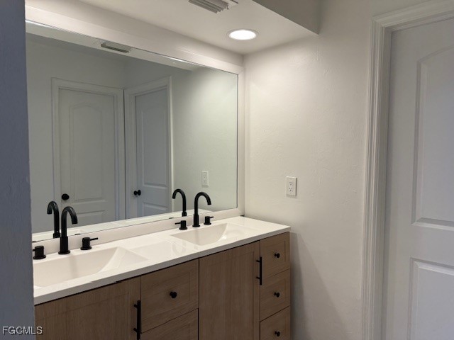 3906 13th Street West Lehigh Acres, FL 33971 - Photo 9 of 26 a bathroom with a sink and a mirror