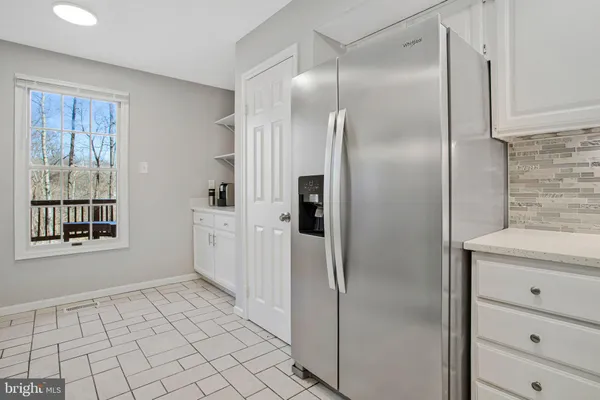 a bathroom with a granite countertop shower a mirror and a sink