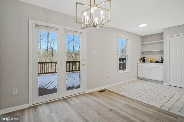 a view of a kitchen with wooden floor and windows