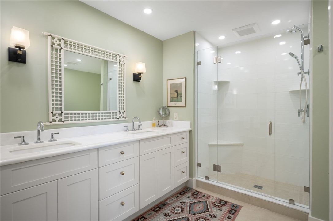 1050 Reef Road, Unit 102 Vero Beach, FL 32963 - Photo 13 of 36 a bathroom with a double vanity sink mirror and shower