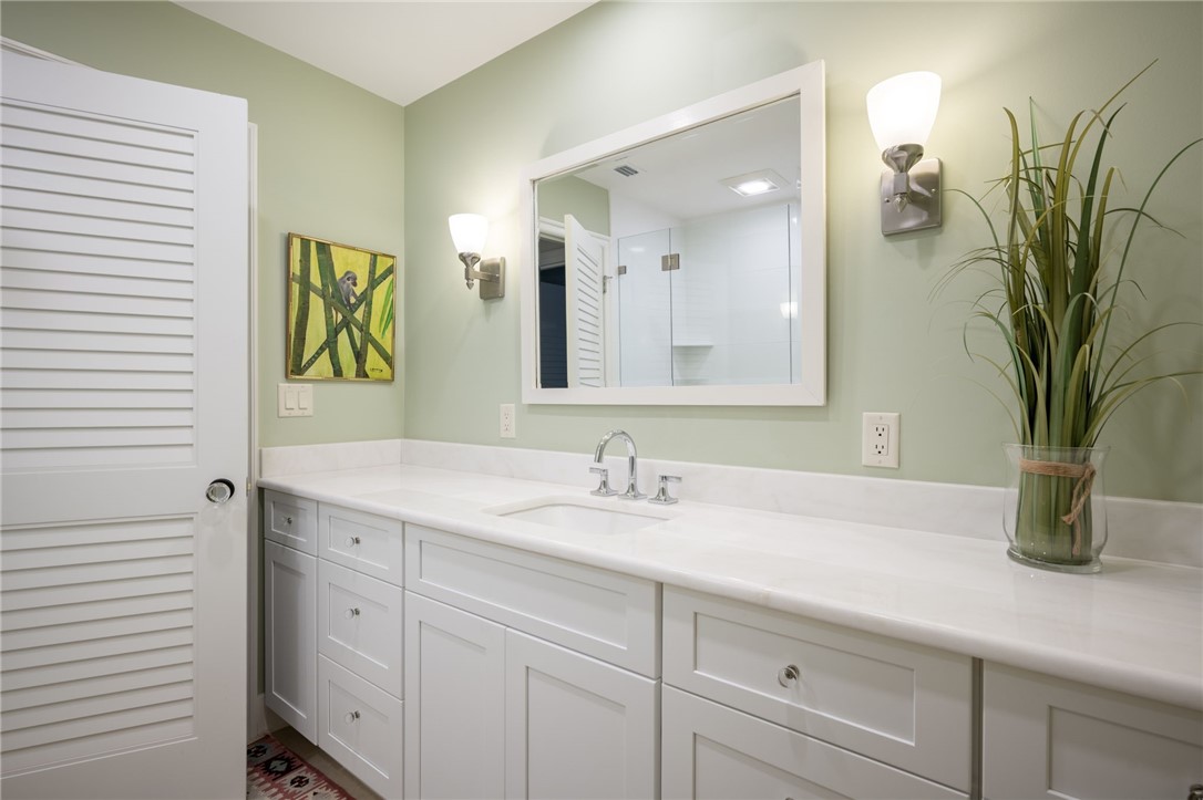 1050 Reef Road, Unit 102 Vero Beach, FL 32963 - Photo 16 of 36 a bathroom with a sink and a mirror