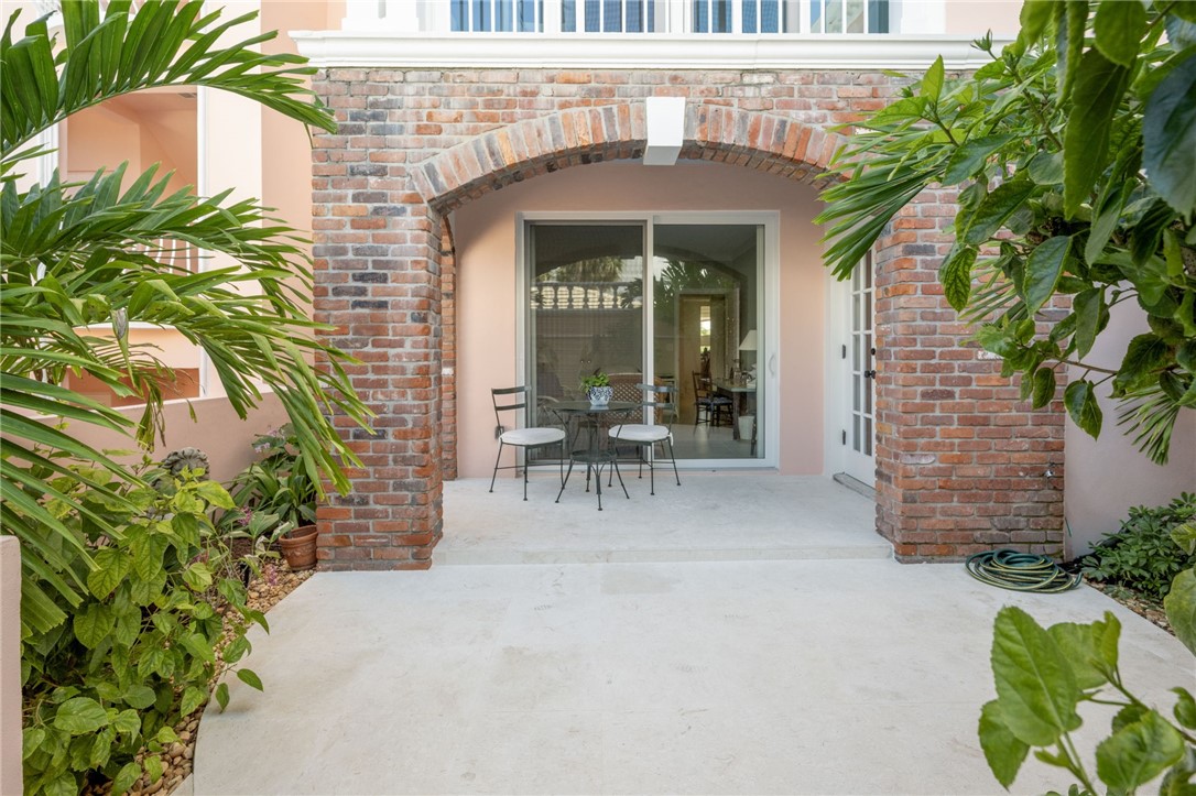 1050 Reef Road, Unit 102 Vero Beach, FL 32963 - Photo 19 of 36 a view of a patio with table and chairs and potted plants