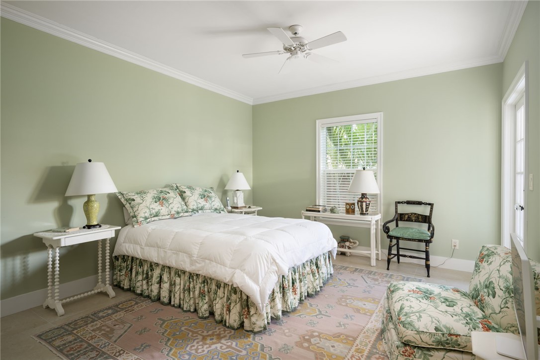1050 Reef Road, Unit 102 Vero Beach, FL 32963 - Photo 20 of 36 a bedroom with a bed and a chandelier