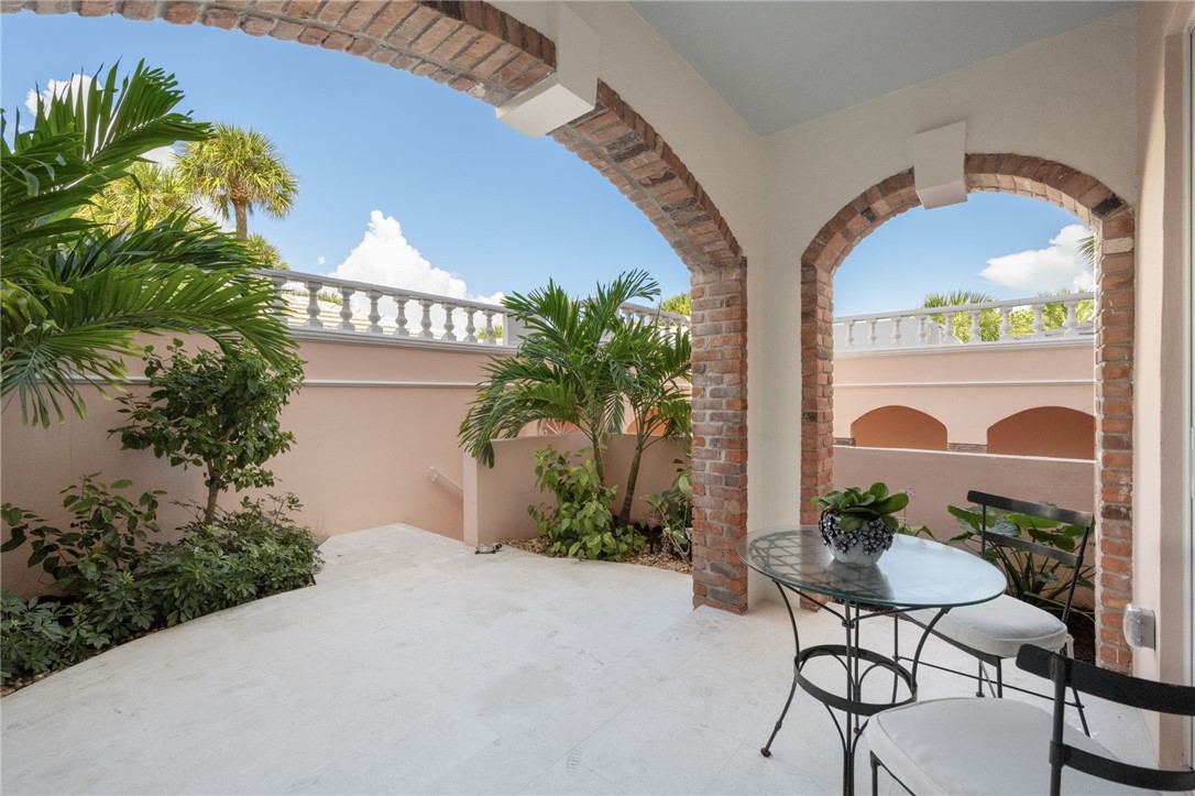 1050 Reef Road, Unit 102 Vero Beach, FL 32963 - Photo 22 of 36 a view of a balcony with potted plants and a large tree