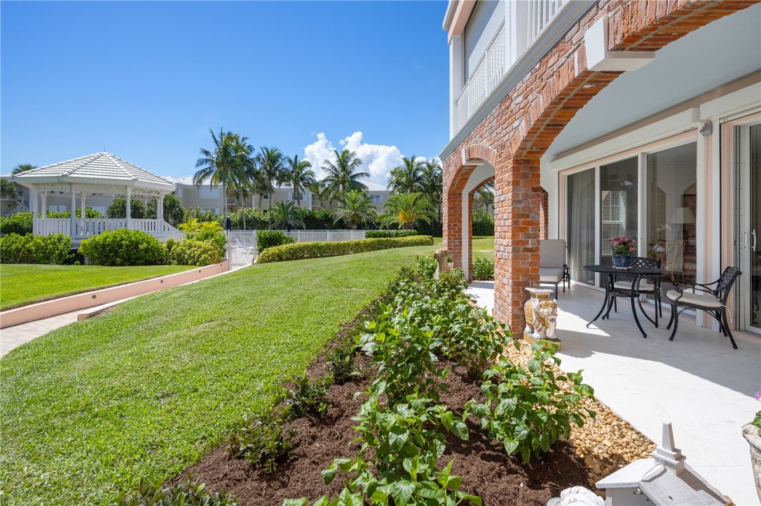 1050 Reef Road, Unit 102 Vero Beach, FL 32963 - Photo 24 of 36 a front view of a house with garden and porch