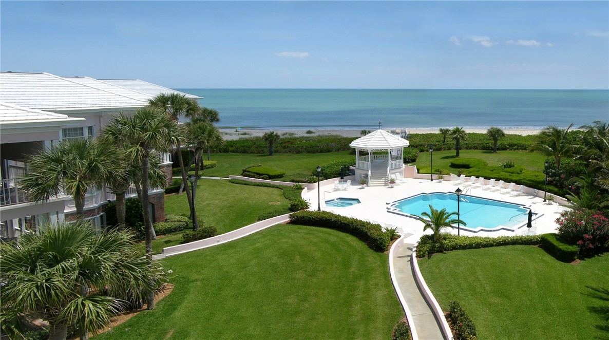 1050 Reef Road, Unit 102 Vero Beach, FL 32963 - Photo 31 of 36 a view of a swimming pool with a yard
