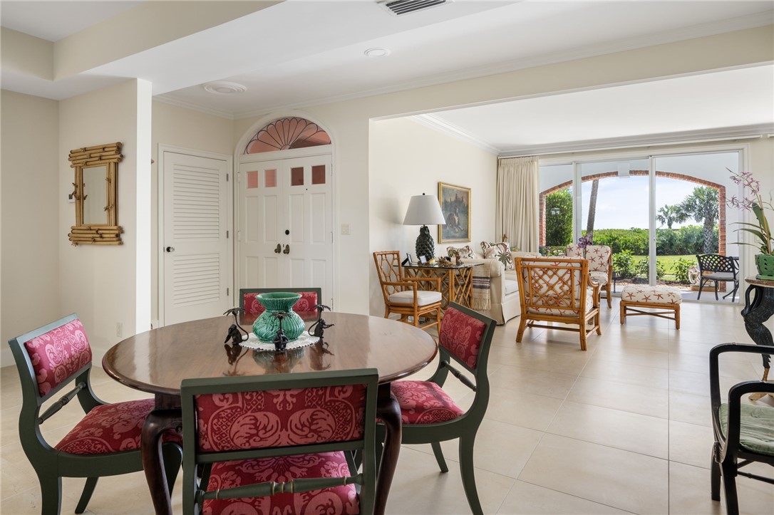 1050 Reef Road, Unit 102 Vero Beach, FL 32963 - Photo 4 of 36 a living room with furniture and a large window