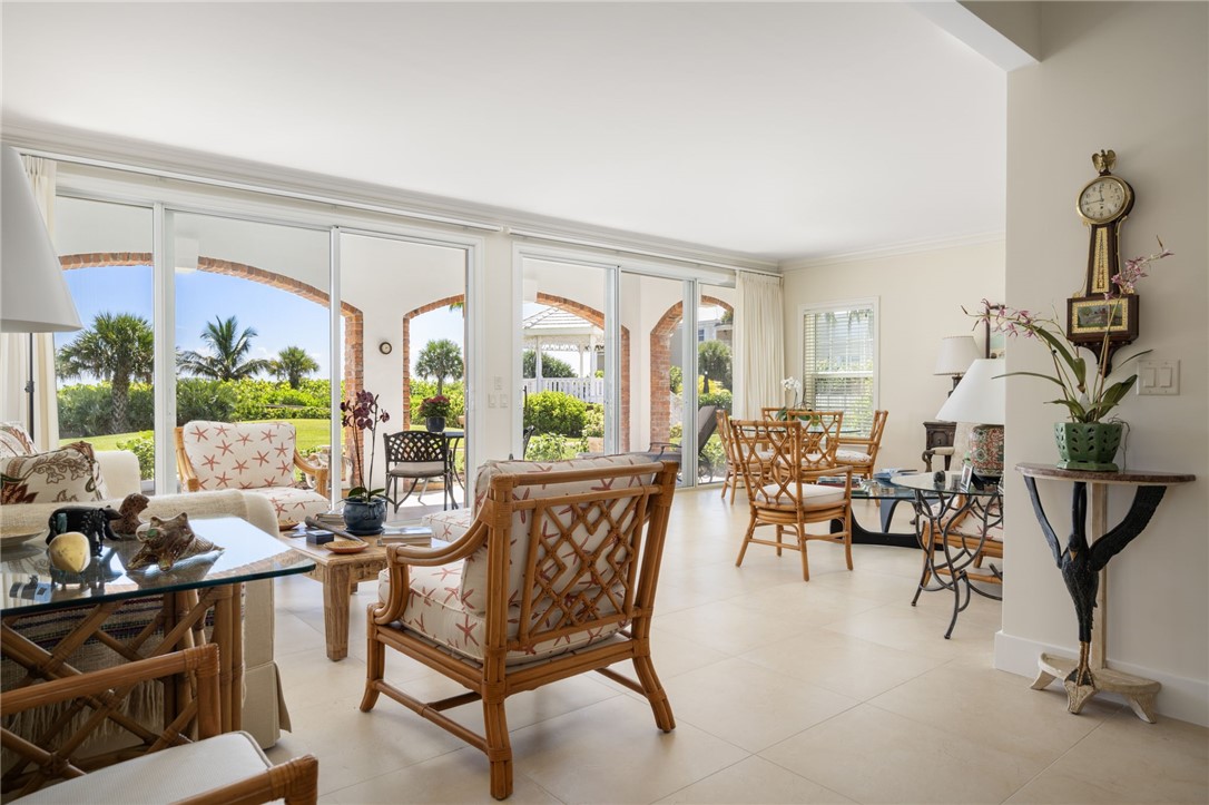 1050 Reef Road, Unit 102 Vero Beach, FL 32963 - Photo 6 of 36 a living room with furniture and a large window