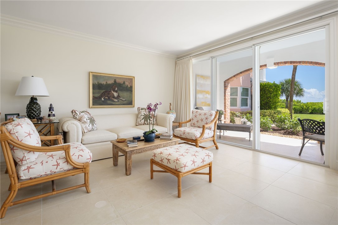1050 Reef Road, Unit 102 Vero Beach, FL 32963 - Photo 7 of 36 a living room with furniture and a floor to ceiling window