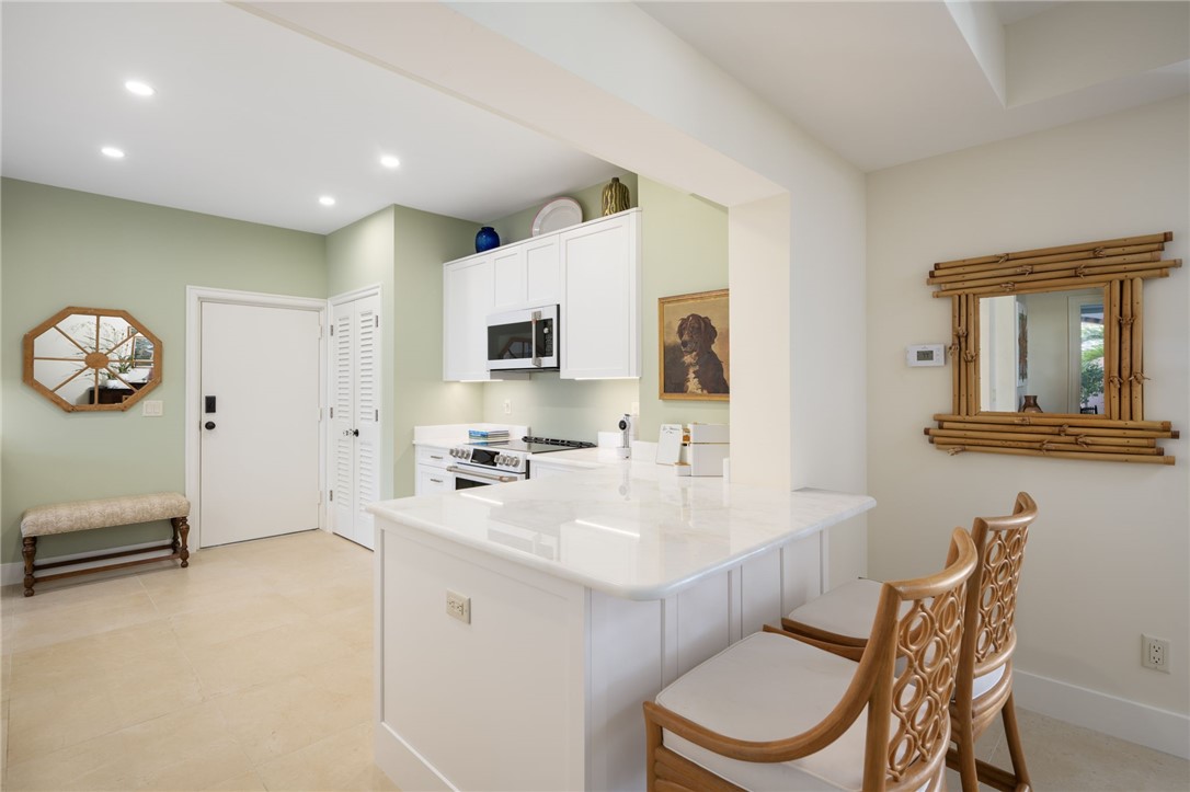 1050 Reef Road, Unit 102 Vero Beach, FL 32963 - Photo 10 of 36 a kitchen with a sink cabinets and window