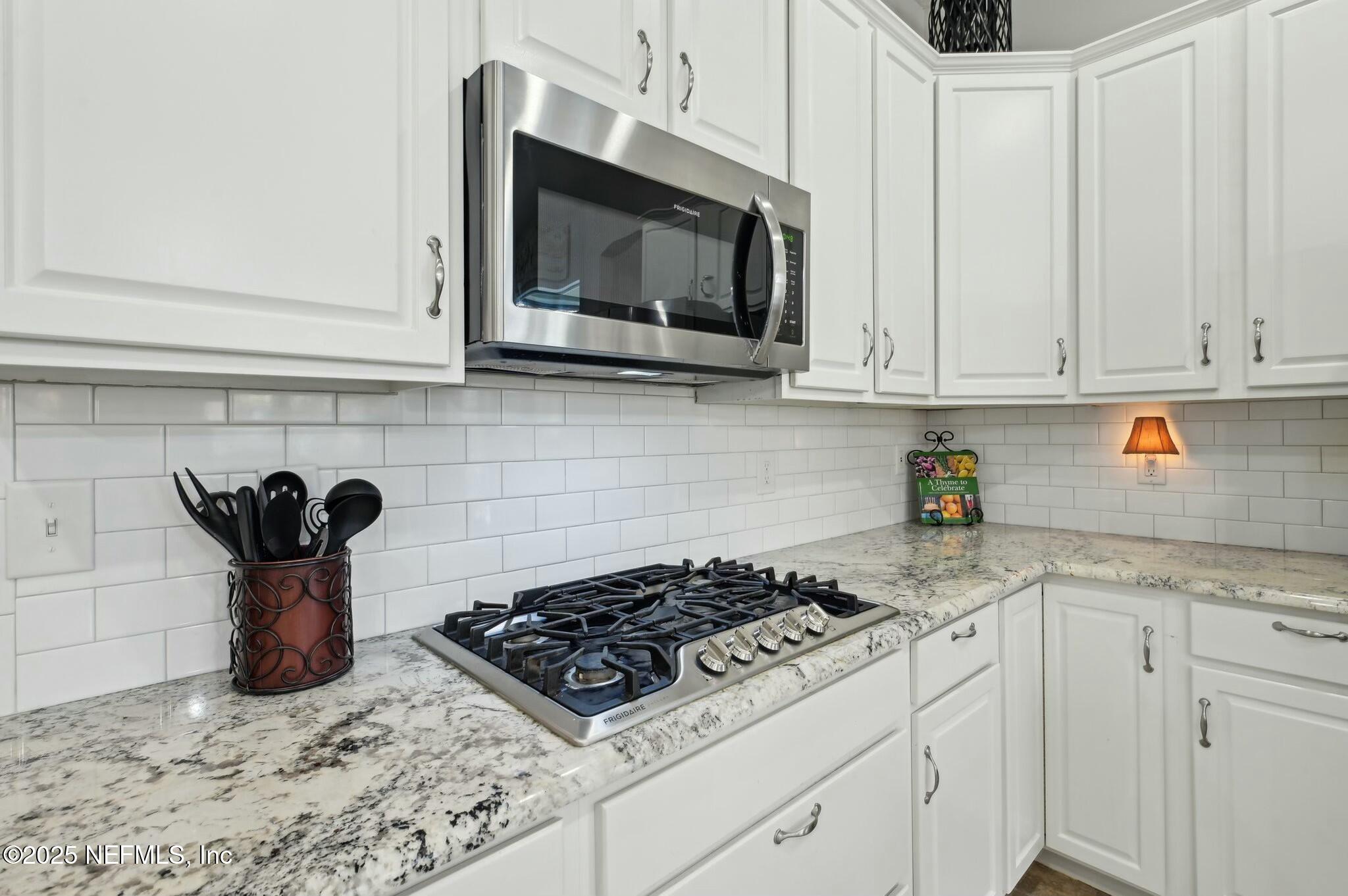 1732 Margarets Walk Road Fleming Island, FL 32003 - Photo 12 of 55 a kitchen with a stove and a white cabinets