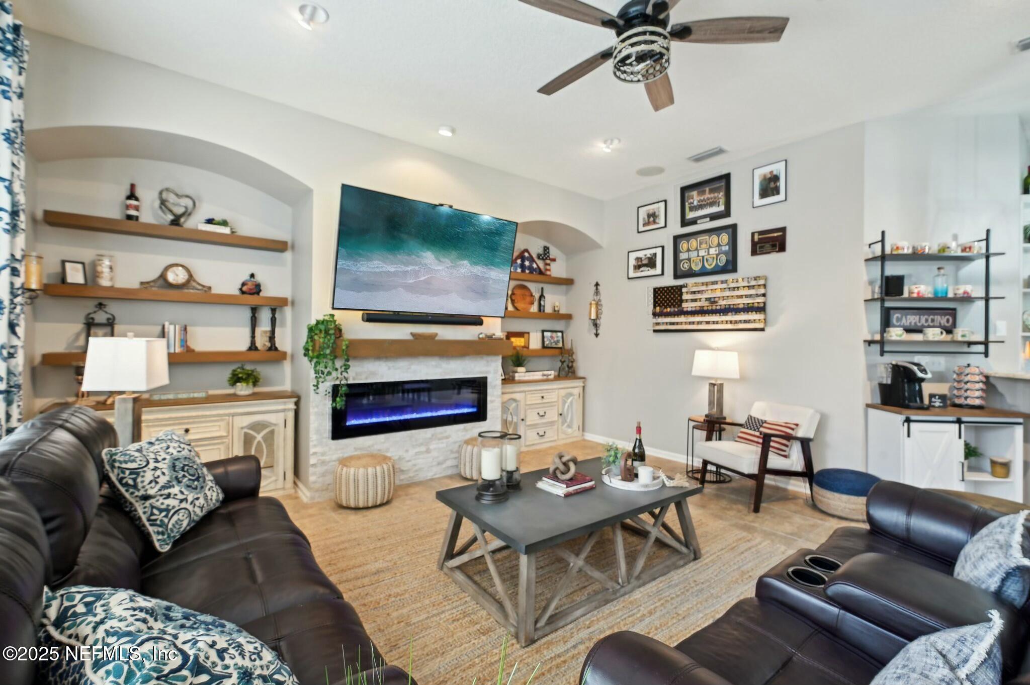 1732 Margarets Walk Road Fleming Island, FL 32003 - Photo 16 of 55 a living room with furniture and a flat screen tv