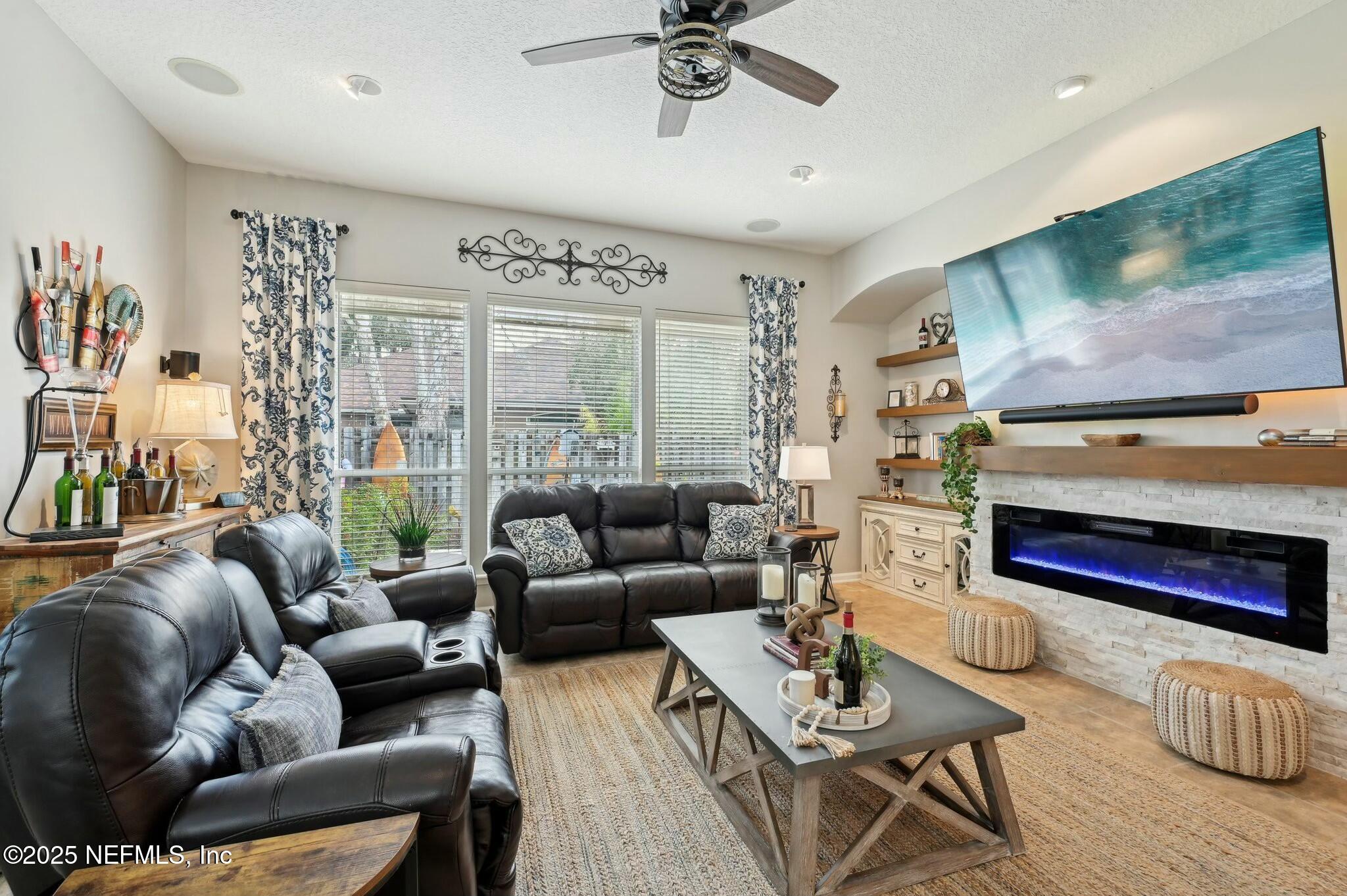 1732 Margarets Walk Road Fleming Island, FL 32003 - Photo 17 of 55 a living room with furniture and a flat screen tv
