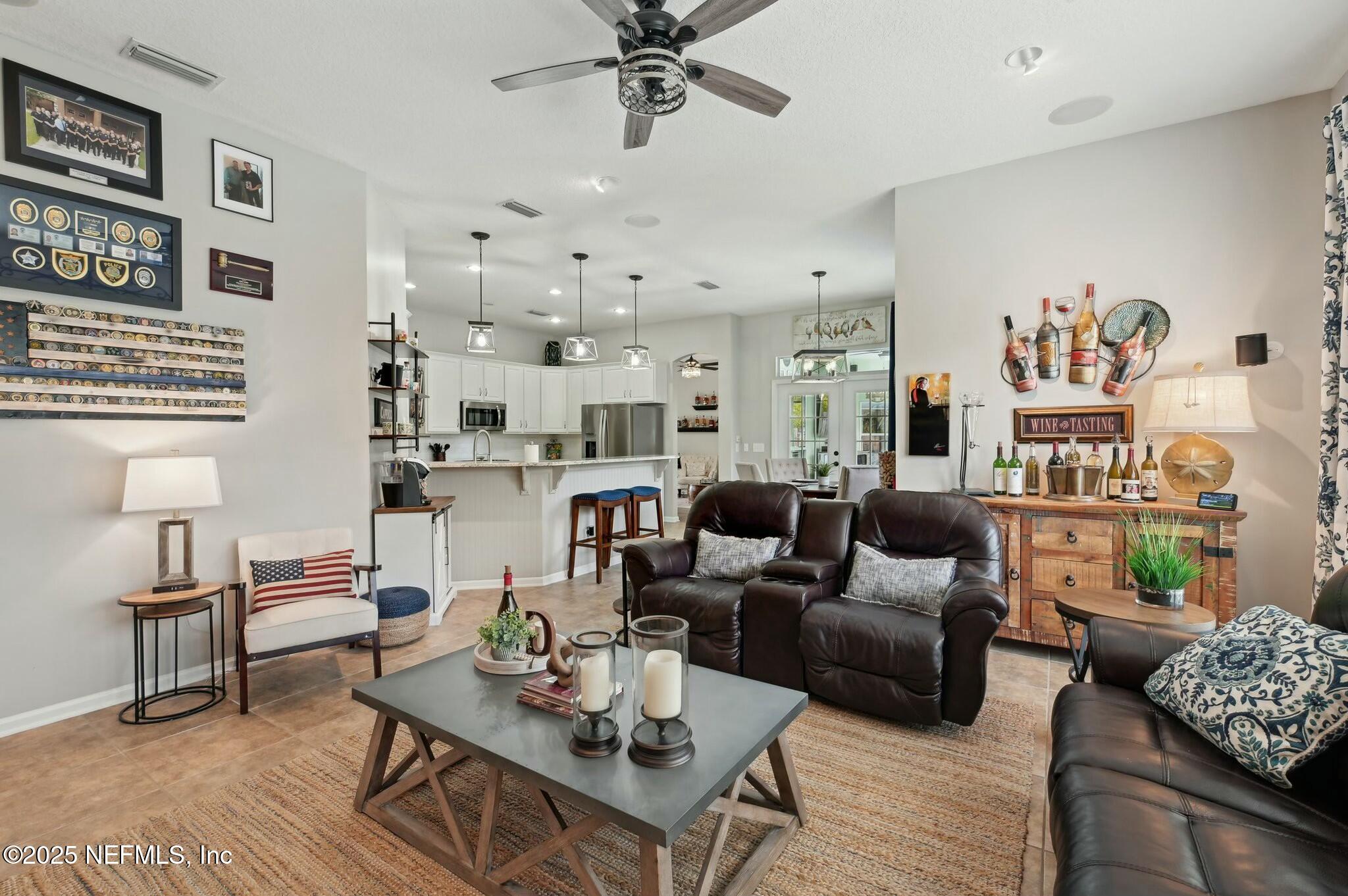 1732 Margarets Walk Road Fleming Island, FL 32003 - Photo 19 of 55 a living room with furniture kitchen view and a table