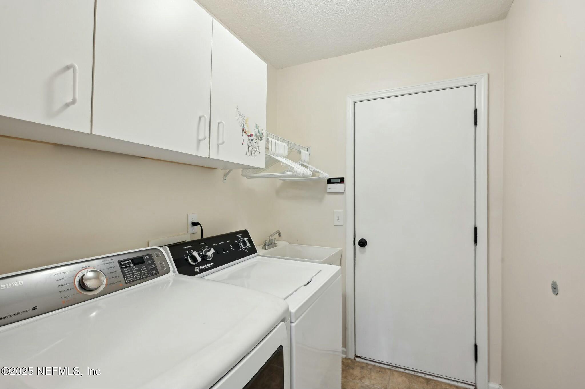 1732 Margarets Walk Road Fleming Island, FL 32003 - Photo 20 of 55 a utility room with dryer and cabinets